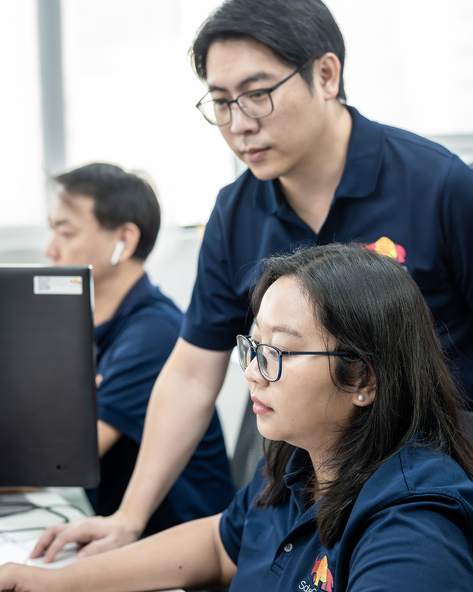 SafeComs team members collaborating in the office.